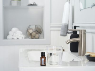 Glass of water and a white towel on bench